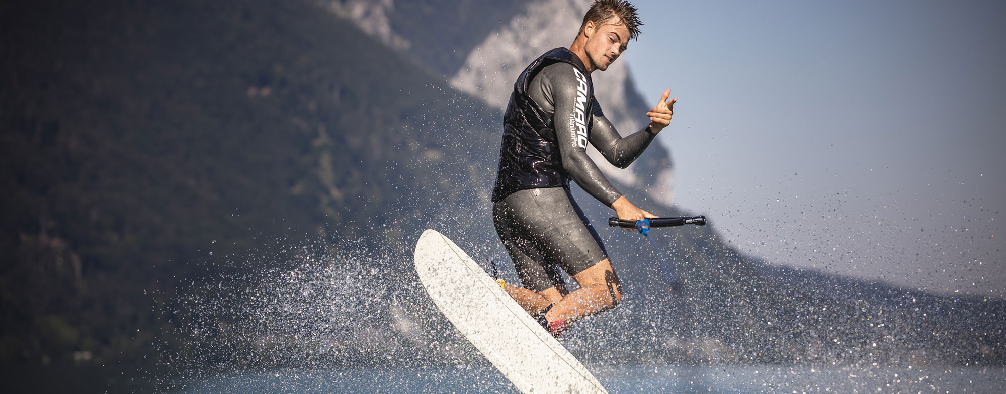 Man wears water ski wetsuits while waterskiing