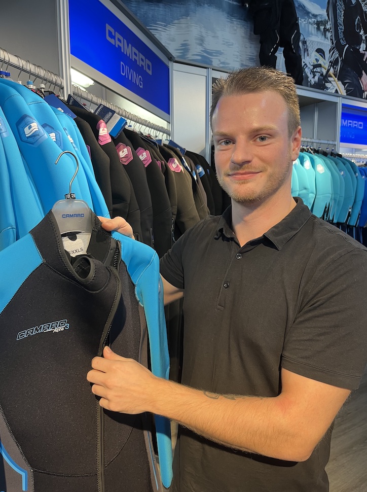 Man sorts suits in factory store